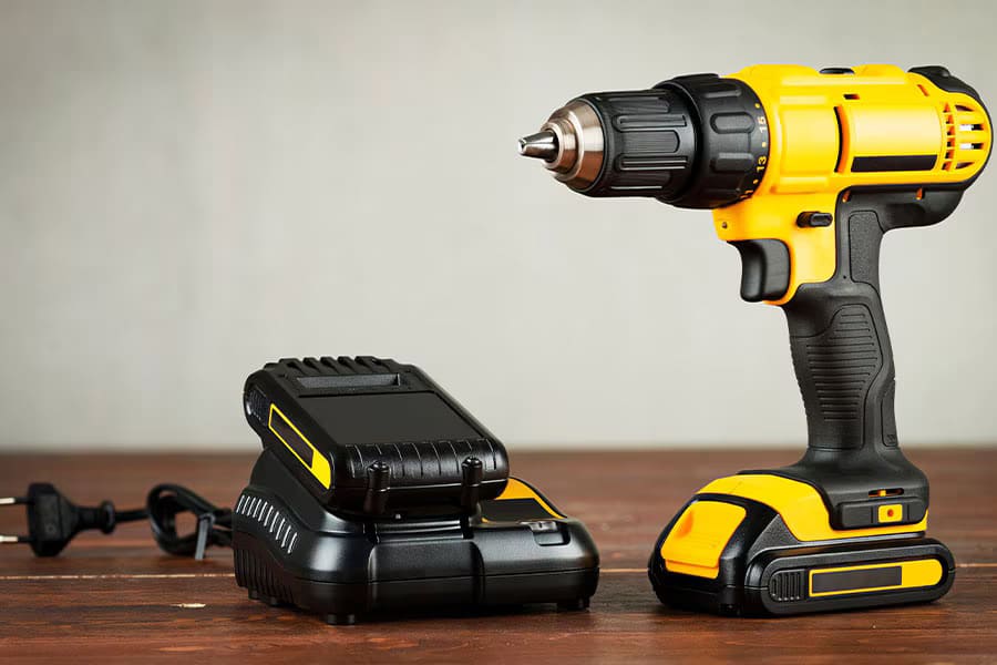 A yellow and black drill and battery